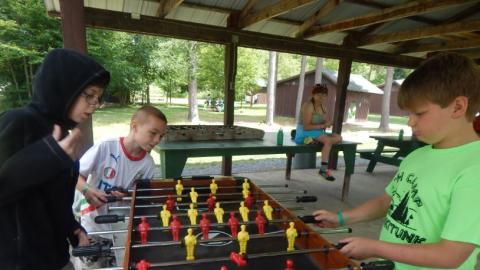 Youth playing a friendly game of Foosball. 