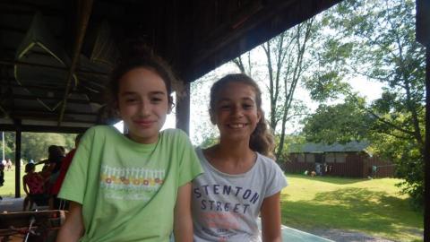 Two youth smile for the camera. 