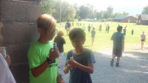 Youth eat their snacks before throwing them in the garbage. 