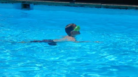 Youth swimming in the camp pool. 