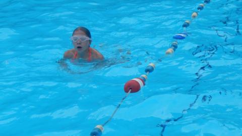 campers takes a breath during swimming lap