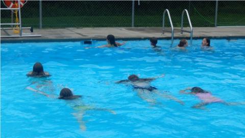 campers swimming in camp pool 
