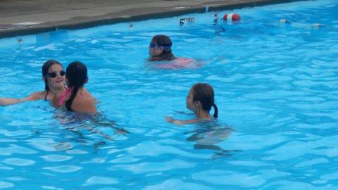 campers swim in the camp pool. 