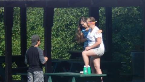 Youth doing a trust walk with blind folds. 