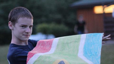 camper holding a paper flag