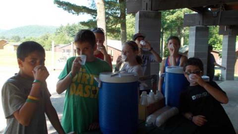 campers drinking water under pavilion 