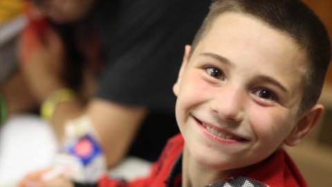 camper smiling with milk carton on table