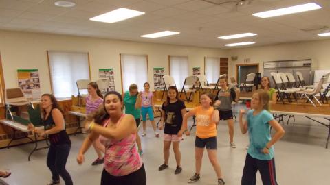 campers doing yoga in camp dining hall 