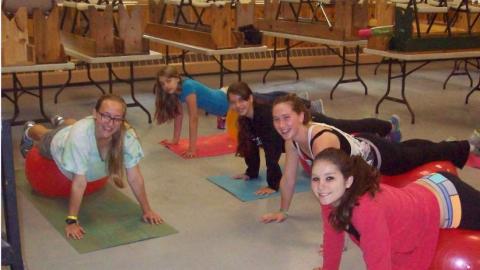 Youth exercise using large rubber balls. 